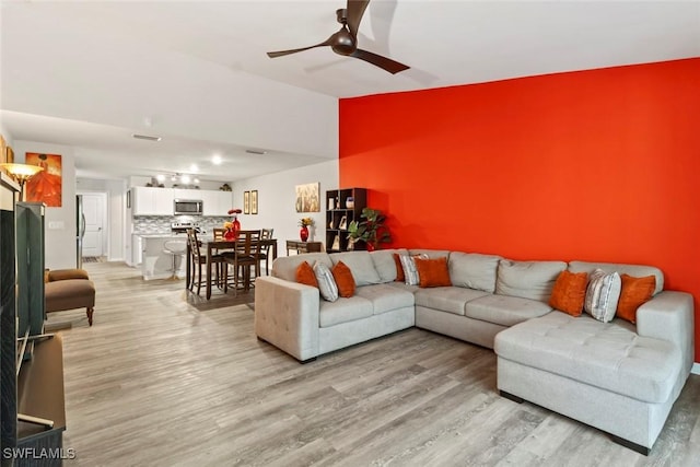 9059 Aegean Cir, Lehigh Acres, FL 33936 - living area with light wood-type flooring and ceiling fan