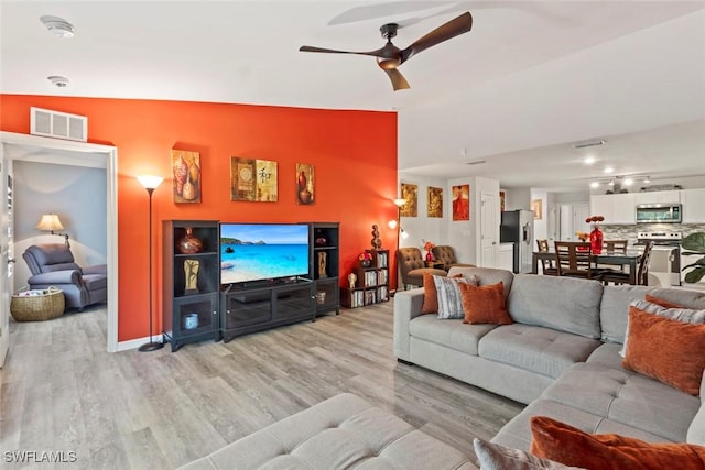 9059 Aegean Cir, Lehigh Acres, FL 33936 - living room featuring light wood finished floors and ceiling fan