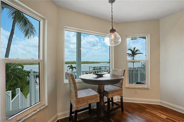 4031 Bayside Rd, Fort Myers Beach, FL 33931 - dining space with dark wood-style floors and a water view