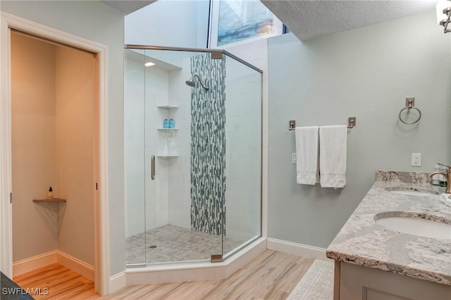 4031 Bayside Rd, Fort Myers Beach, FL 33931 - full bathroom with wood finished floors, a stall shower, and double vanity
