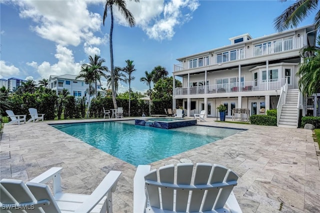 4031 Bayside Rd, Fort Myers Beach, FL 33931 - view of swimming pool featuring a patio area, stairs, a pool with connected hot tub, and french doors