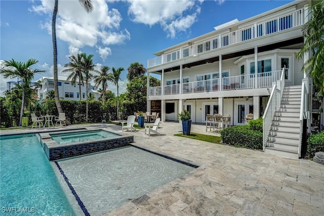 4031 Bayside Rd, Fort Myers Beach, FL 33931 - view of swimming pool with a patio area, stairs, french doors, and a pool with connected hot tub