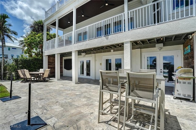 4031 Bayside Rd, Fort Myers Beach, FL 33931 - patio / terrace featuring french doors, outdoor dining space, a patio area, and area for grilling