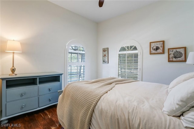4031 Bayside Rd, Fort Myers Beach, FL 33931 - bedroom featuring dark wood-style flooring, arched walkways, and a ceiling fan