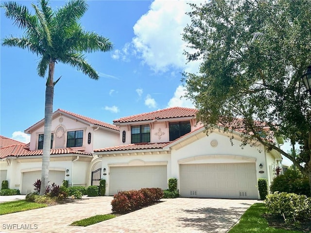 3165 Aviamar Cir Unit 102, Naples, FL 34114 - mediterranean / spanish home with stucco siding, decorative driveway, and a tile roof