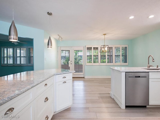 1486 13th Ave N, Naples, FL 34102 - kitchen with dishwasher, light wood finished floors, white cabinets, recessed lighting, and light stone counters