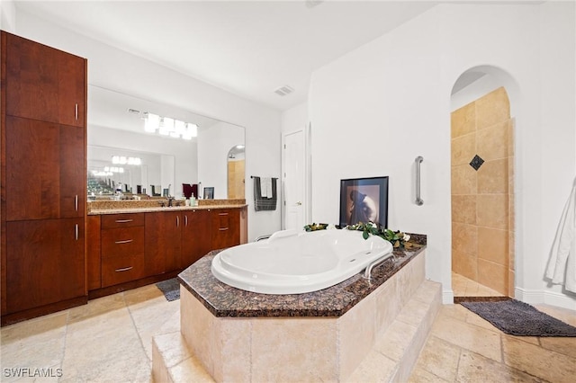 4007 Surfside Blvd, Cape Coral, FL 33914 - full bath featuring a tub with jets, vanity, and a walk in shower