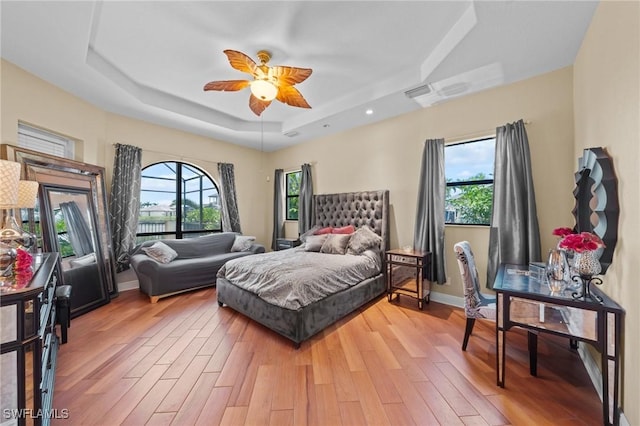 4007 Surfside Blvd, Cape Coral, FL 33914 - bedroom featuring a tray ceiling, light wood-style flooring, and ceiling fan