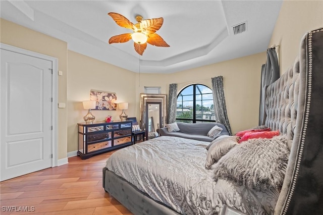 4007 Surfside Blvd, Cape Coral, FL 33914 - bedroom with a raised ceiling, light wood-style floors, and ceiling fan