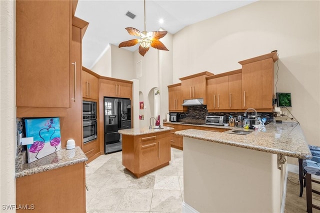4007 Surfside Blvd, Cape Coral, FL 33914 - kitchen with stainless steel oven, built in microwave, a peninsula, black refrigerator with ice dispenser, and ceiling fan