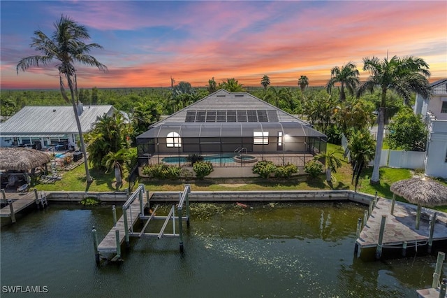 4007 Surfside Blvd, Cape Coral, FL 33914 - rear view of property featuring an outdoor pool, a water view, a patio area, and glass enclosure