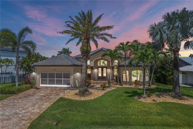 4007 Surfside Blvd, Cape Coral, FL 33914 - view of front of house featuring french doors, an attached garage, decorative driveway, and stucco siding