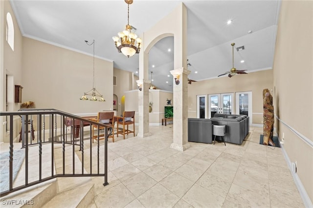 4007 Surfside Blvd, Cape Coral, FL 33914 - living area with arched walkways, a chandelier, a towering ceiling, ornate columns, and crown molding