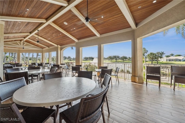 13090 Amberley Ct Unit 1103, Bonita Springs, FL 34135 - wooden deck featuring a ceiling fan and outdoor dining area