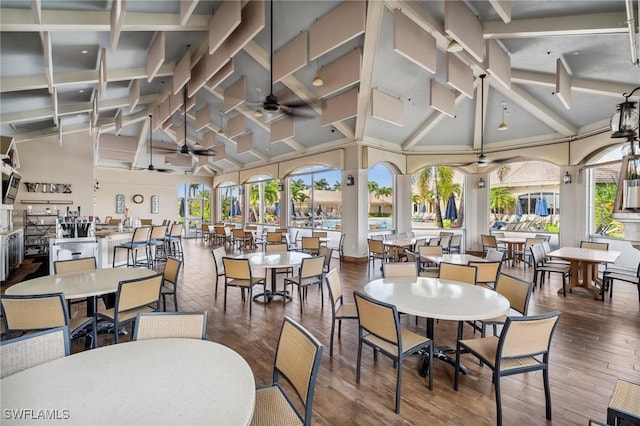 13090 Amberley Ct Unit 1103, Bonita Springs, FL 34135 - dining space with ceiling fan, high vaulted ceiling, beamed ceiling, and wood finished floors