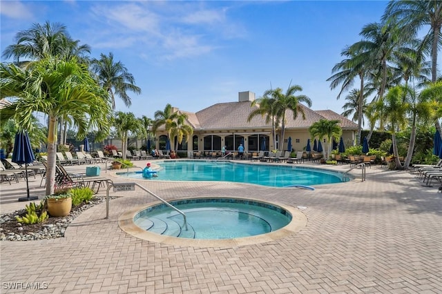 13090 Amberley Ct Unit 1103, Bonita Springs, FL 34135 - community pool with a hot tub and a patio area