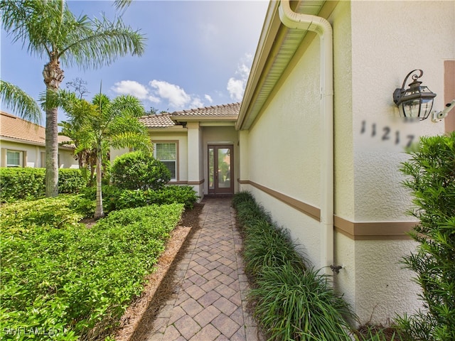 11217 Suffield St, Fort Myers, FL 33913 - property entrance with stucco siding and a tile roof