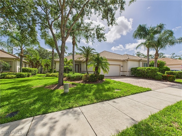 11217 Suffield St, Fort Myers, FL 33913 - view of front of house featuring driveway, an attached garage, stucco siding, a front yard, and a tile roof