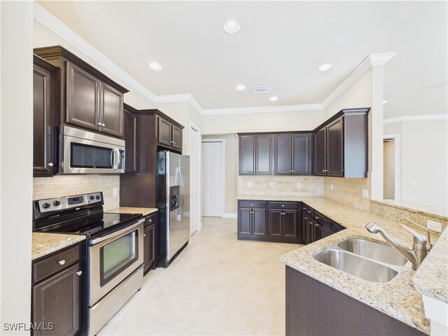 11217 Suffield St, Fort Myers, FL 33913 - kitchen featuring stainless steel appliances, light stone countertops, dark brown cabinetry, decorative backsplash, and recessed lighting