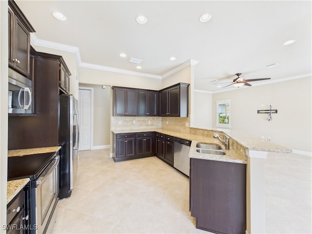 11217 Suffield St, Fort Myers, FL 33913 - kitchen with stainless steel appliances, a peninsula, dark brown cabinets, backsplash, and ornamental molding