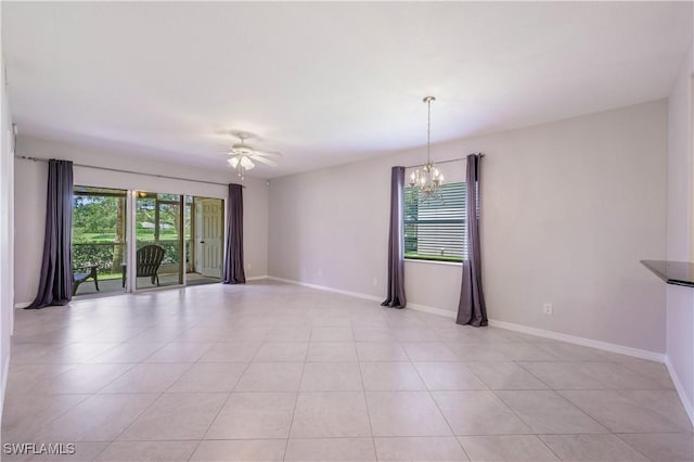 12330 Notting Hill Ln Unit 14, Bonita Springs, FL 34135 - empty room featuring a chandelier, a ceiling fan, and light tile patterned floors