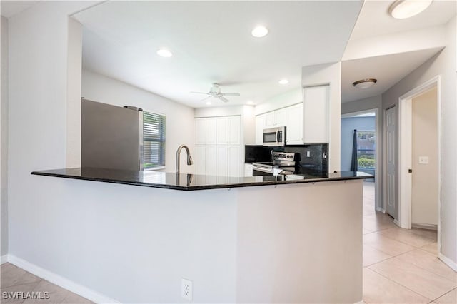 12330 Notting Hill Ln Unit 14, Bonita Springs, FL 34135 - kitchen featuring appliances with stainless steel finishes, a peninsula, a ceiling fan, light tile patterned floors, and recessed lighting