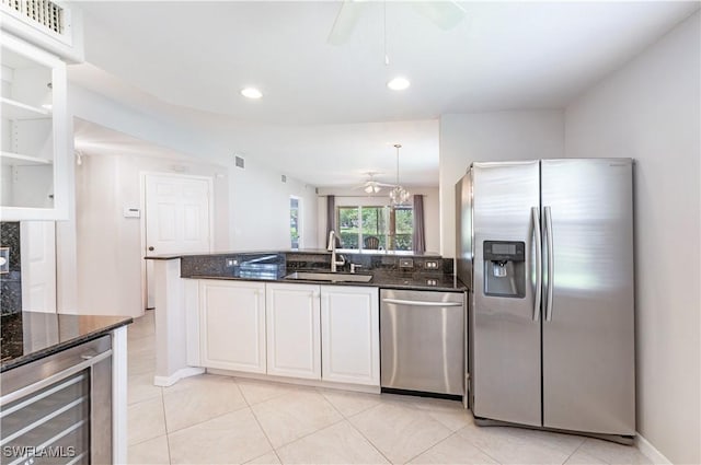 12330 Notting Hill Ln Unit 14, Bonita Springs, FL 34135 - kitchen featuring appliances with stainless steel finishes, ceiling fan, dark stone countertops, a peninsula, and recessed lighting