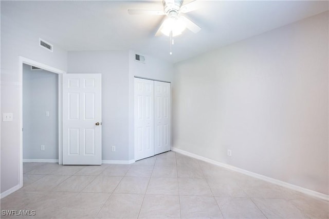 12330 Notting Hill Ln Unit 14, Bonita Springs, FL 34135 - unfurnished bedroom with a closet, light tile patterned floors, and ceiling fan