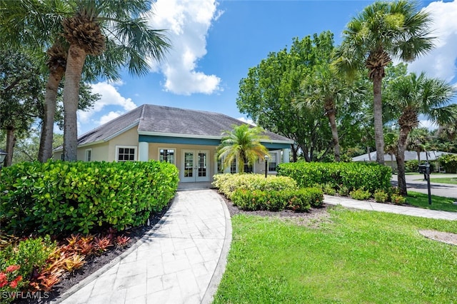 12330 Notting Hill Ln Unit 14, Bonita Springs, FL 34135 - view of front of house with french doors, a front lawn, stucco siding, and a shingled roof