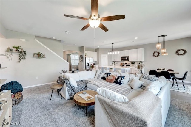 43837 Cattleman Dr, Punta Gorda, FL 33982 - carpeted living room with a ceiling fan, recessed lighting, and stairway