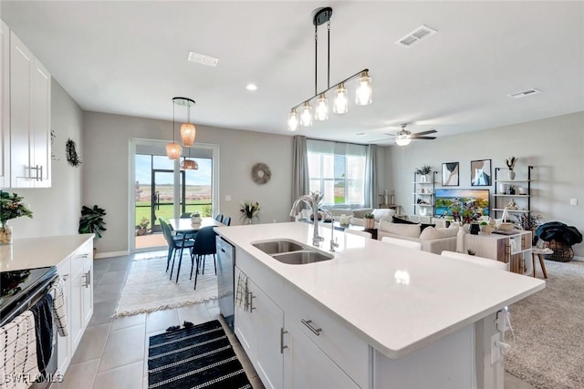 43837 Cattleman Dr, Punta Gorda, FL 33982 - kitchen with black stove, dishwasher, plenty of natural light, white cabinetry, and recessed lighting