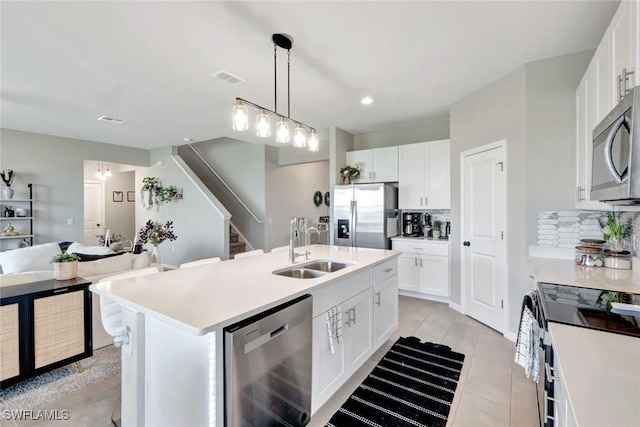 43837 Cattleman Dr, Punta Gorda, FL 33982 - kitchen with stainless steel appliances, tasteful backsplash, light countertops, white cabinetry, and recessed lighting