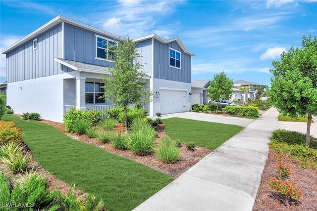 43837 Cattleman Dr, Punta Gorda, FL 33982 - view of front facade featuring board and batten siding, driveway, a garage, and a front lawn