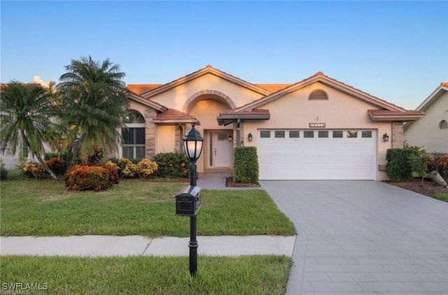 16131 Kelly Woods Dr, Fort Myers, FL 33908 - view of front of house with stucco siding, a garage, driveway, and a front lawn