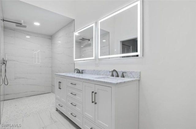 16131 Kelly Woods Dr, Fort Myers, FL 33908 - full bath featuring marble look tiles, double vanity, a marble finish shower, and recessed lighting