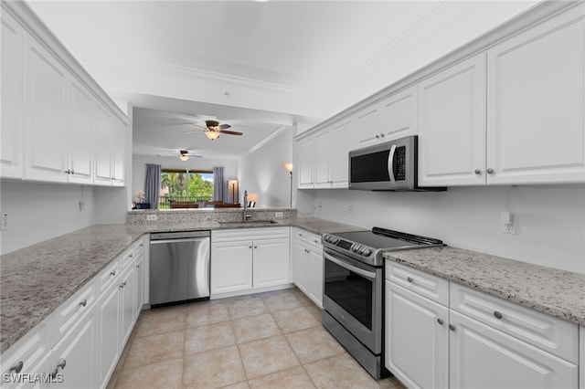 8550 Kingbird Loop Unit 629, Estero, FL 33967 - kitchen featuring appliances with stainless steel finishes, ornamental molding, white cabinetry, ceiling fan, and light stone counters