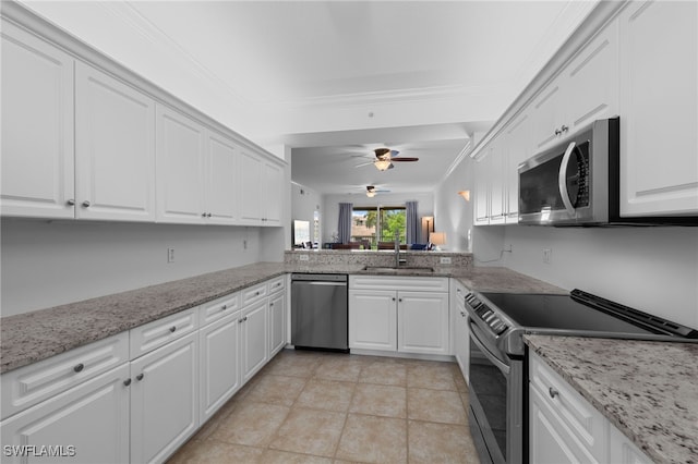 8550 Kingbird Loop Unit 629, Estero, FL 33967 - kitchen with stainless steel appliances, a ceiling fan, white cabinetry, ornamental molding, and light stone countertops