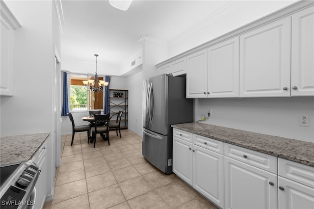 8550 Kingbird Loop Unit 629, Estero, FL 33967 - kitchen with freestanding refrigerator, stove, a chandelier, white cabinetry, and crown molding