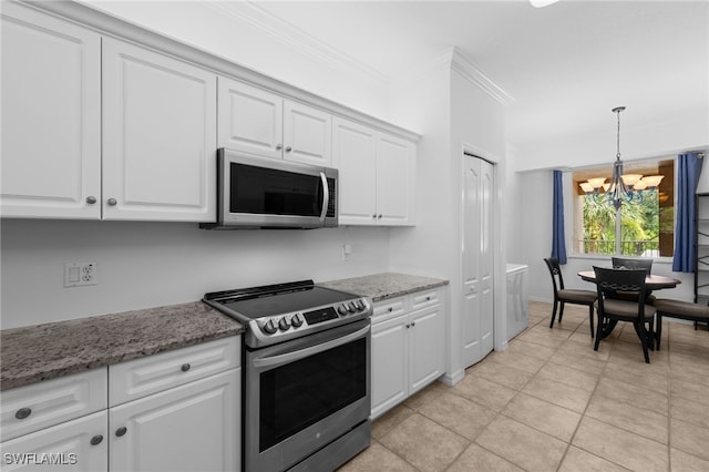 8550 Kingbird Loop Unit 629, Estero, FL 33967 - kitchen featuring stainless steel appliances, a chandelier, ornamental molding, white cabinets, and pendant lighting