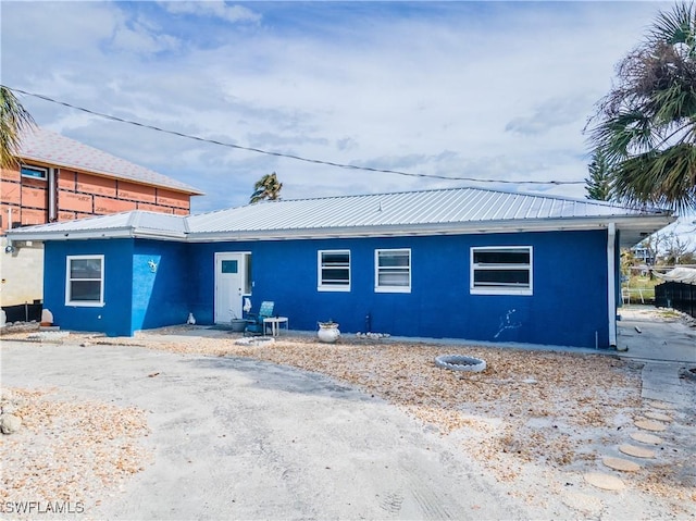208 Flamingo St, Fort Myers Beach, FL 33931 - view of front of property with stucco siding and a metal roof