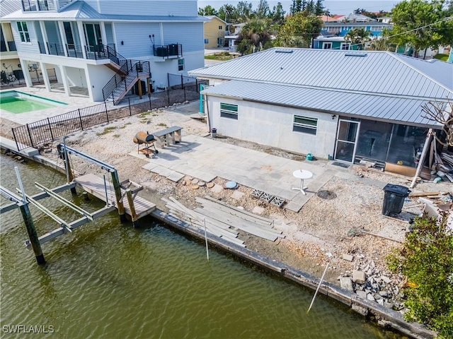 208 Flamingo St, Fort Myers Beach, FL 33931 - rear view of property with a sunroom, stairs, a fenced backyard, a patio area, and boat lift