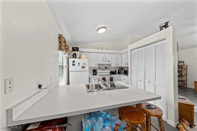 1720 NW 14th Pl, Cape Coral, FL 33993 - kitchen featuring white appliances, lofted ceiling, a peninsula, white cabinetry, and under cabinet range hood