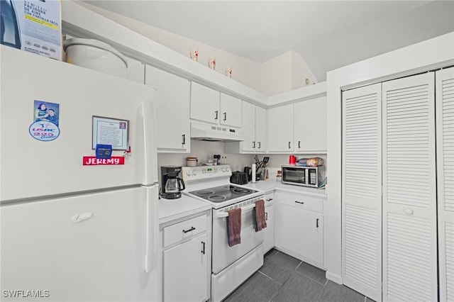 1720 NW 14th Pl, Cape Coral, FL 33993 - kitchen featuring white appliances, under cabinet range hood, light countertops, white cabinetry, and dark tile patterned flooring