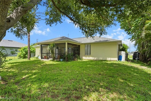 1720 NW 14th Pl, Cape Coral, FL 33993 - rear view of property with a sunroom