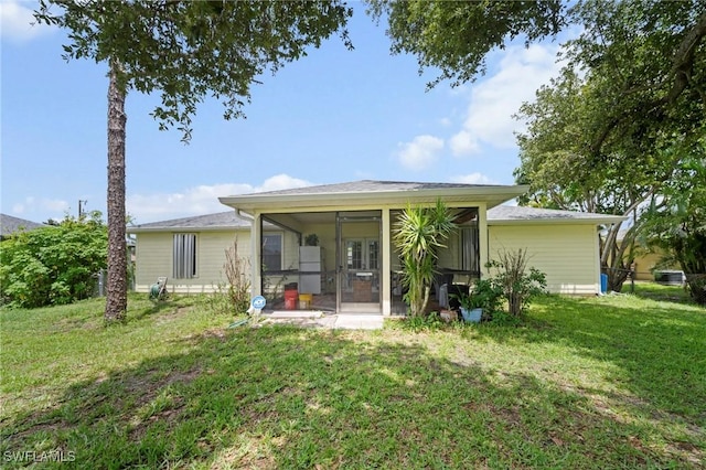 1720 NW 14th Pl, Cape Coral, FL 33993 - back of property featuring a sunroom and a lawn