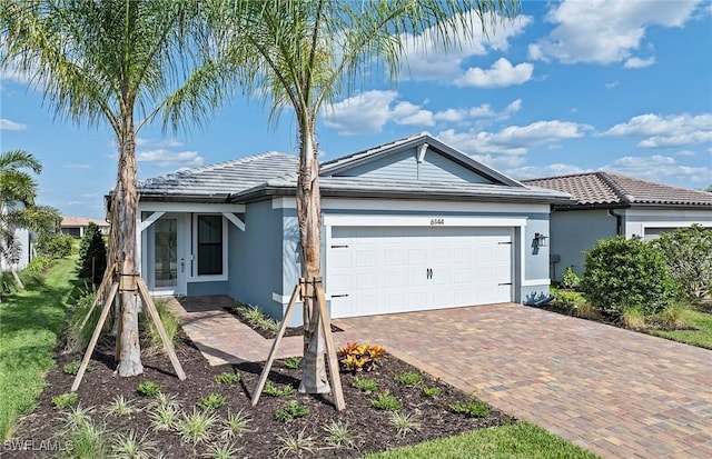 6144 Liberty St, Ave Maria, FL 34142 - single story home with stucco siding, an attached garage, decorative driveway, and a tiled roof