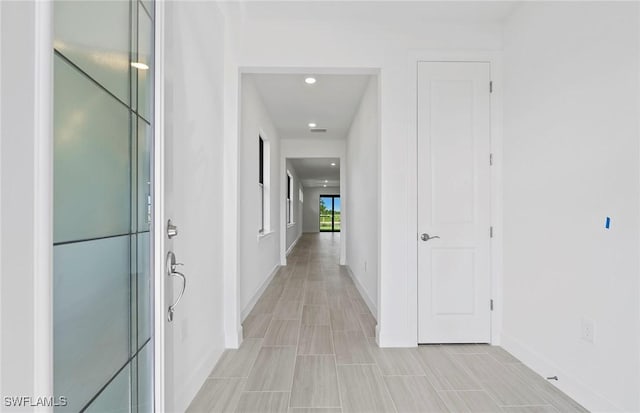 6144 Liberty St, Ave Maria, FL 34142 - hallway featuring baseboards and recessed lighting