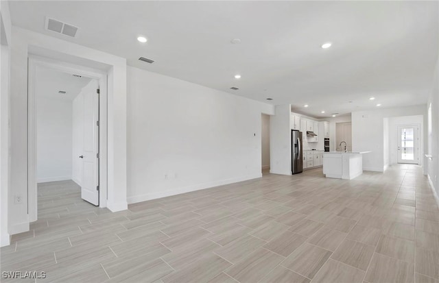 6144 Liberty St, Ave Maria, FL 34142 - unfurnished living room with light wood-style floors and recessed lighting