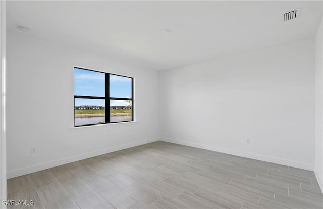 6144 Liberty St, Ave Maria, FL 34142 - empty room featuring a smoke detector and a water view