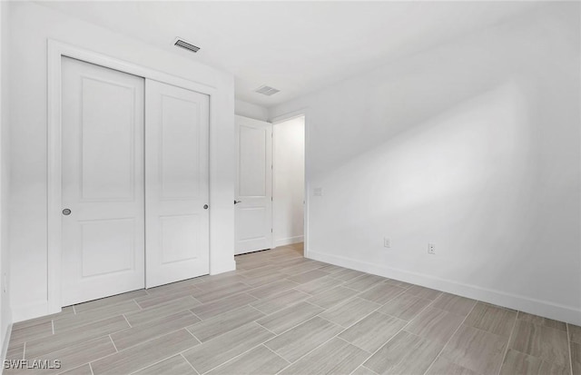 6144 Liberty St, Ave Maria, FL 34142 - unfurnished bedroom with a closet and wood finish floors